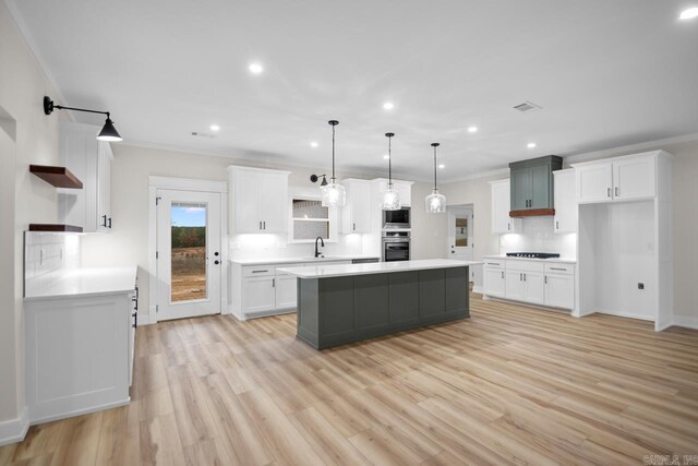 139 Hudson Dr, Sheridan, AR 72150 - kitchen featuring crown molding, open shelves, built in microwave, a sink, and oven