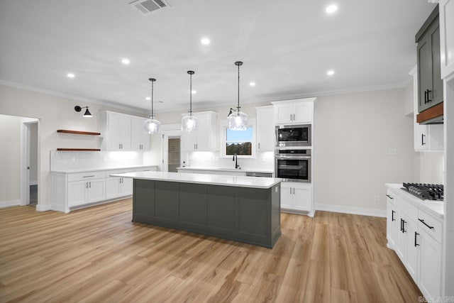 139 Hudson Dr, Sheridan, AR 72150 - kitchen with open shelves, a sink, light countertops, stainless steel appliances, and visible vents