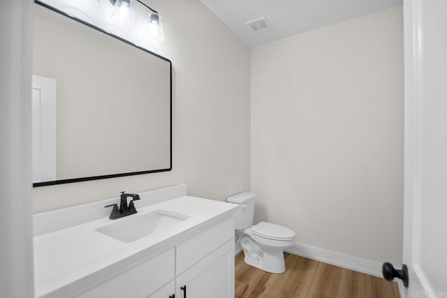 139 Hudson Dr, Sheridan, AR 72150 - half bath featuring vanity, toilet, baseboards, wood finished floors, and visible vents