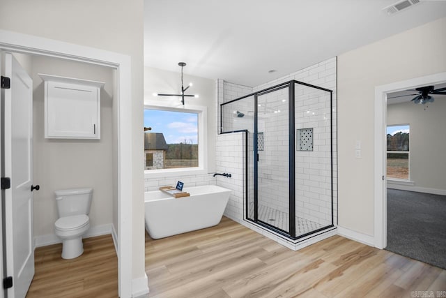 139 Hudson Dr, Sheridan, AR 72150 - full bath featuring a freestanding tub, a stall shower, wood finished floors, and visible vents