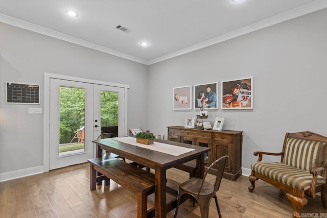 dining room featuring visible vents, ornamental molding, recessed lighting, french doors, and light wood finished floors
