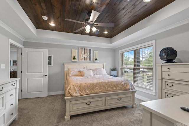bedroom with baseboards, wood ceiling, a tray ceiling, and light carpet