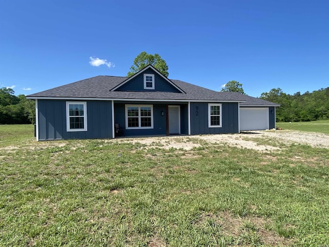 92 Revas Way, Story, AR 71970 - view of front facade with an attached garage, a front lawn, and board and batten siding