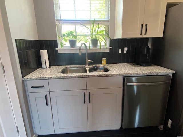 92 Revas Way, Story, AR 71970 - kitchen featuring light stone counters, a sink, dishwasher, white cabinetry, and backsplash