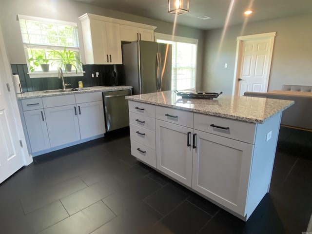 92 Revas Way, Story, AR 71970 - kitchen featuring decorative backsplash, recessed lighting, white cabinetry, a sink, and stainless steel appliances