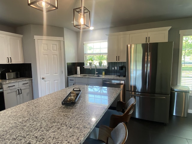 92 Revas Way, Story, AR 71970 - kitchen with white cabinets, stainless steel appliances, a sink, and tasteful backsplash