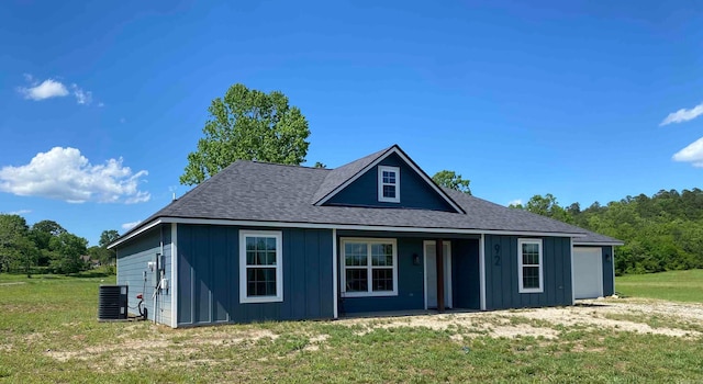 92 Revas Way, Story, AR 71970 - view of front of property featuring a shingled roof, board and batten siding, central air condition unit, and a front yard