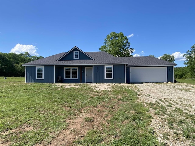 92 Revas Way, Story, AR 71970 - view of front facade with a front yard and a garage