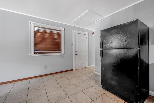 718 W 41st St, North Little Rock, AR 72118 - kitchen featuring freestanding refrigerator, light tile patterned flooring, and baseboards