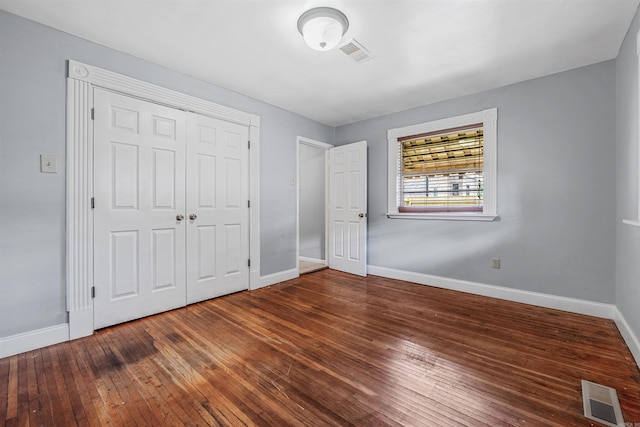 718 W 41st St, North Little Rock, AR 72118 - unfurnished bedroom featuring baseboards, hardwood / wood-style flooring, and visible vents