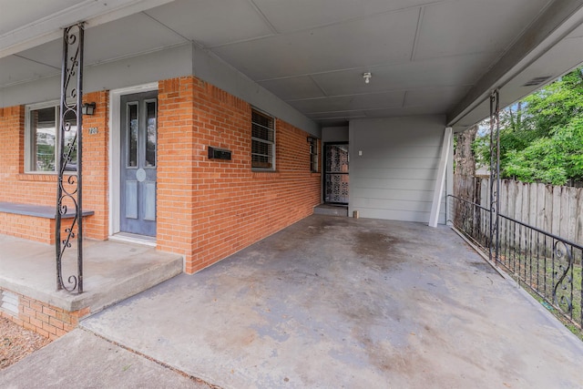718 W 41st St, North Little Rock, AR 72118 - view of patio featuring fence and an attached carport