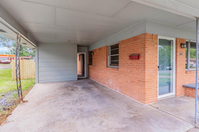 718 W 41st St, North Little Rock, AR 72118 - view of patio featuring fence and an attached carport