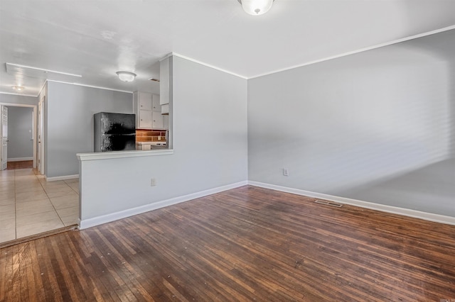 718 W 41st St, North Little Rock, AR 72118 - unfurnished living room with baseboards, hardwood / wood-style floors, and visible vents