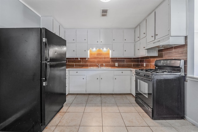 718 W 41st St, North Little Rock, AR 72118 - kitchen featuring visible vents, light tile patterned flooring, under cabinet range hood, white cabinets, and black appliances