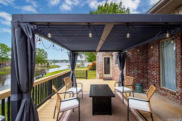 view of patio featuring a deck with water view and outdoor lounge area