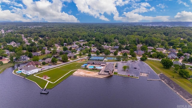 drone / aerial view with a water view and a forest view