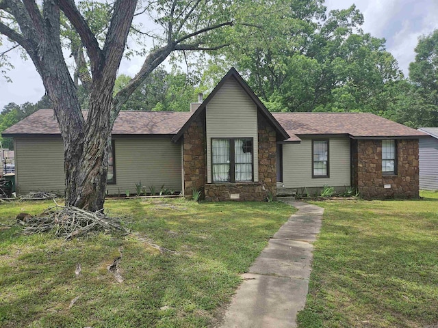 ranch-style home with roof with shingles, a front lawn, and stone siding