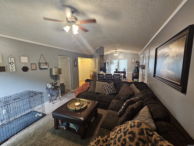 living area with a ceiling fan, carpet floors, a textured ceiling, lofted ceiling, and ornamental molding
