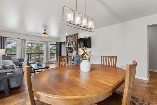 203 Stearns Pt Unit B6, Lake Hamilton, AR 71913 - tiled dining area with baseboards and a stone fireplace