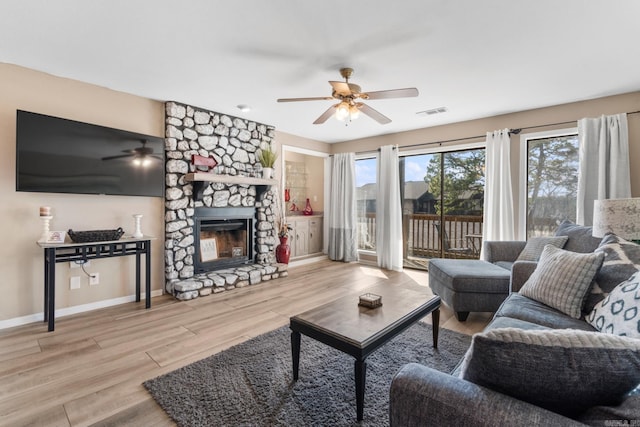 203 Stearns Pt Unit D1, Lake Hamilton, AR 71913 - living area with a fireplace, a ceiling fan, baseboards, wood finished floors, and visible vents