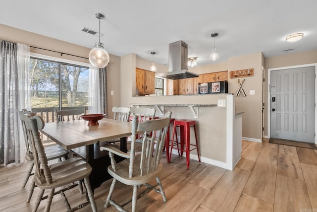 203 Stearns Pt Unit D1, Lake Hamilton, AR 71913 - dining room featuring baseboards, light wood-type flooring, and visible vents
