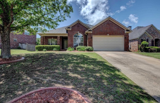 ranch-style home with brick siding, fence, a front lawn, concrete driveway, and an attached garage