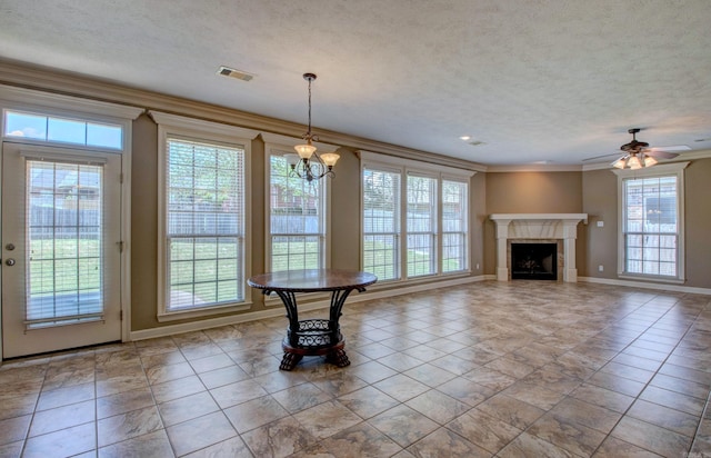 unfurnished dining area featuring plenty of natural light, baseboards, ornamental molding, and visible vents