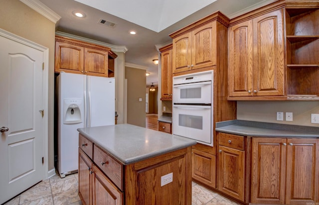 kitchen with visible vents, open shelves, crown molding, white appliances, and a center island
