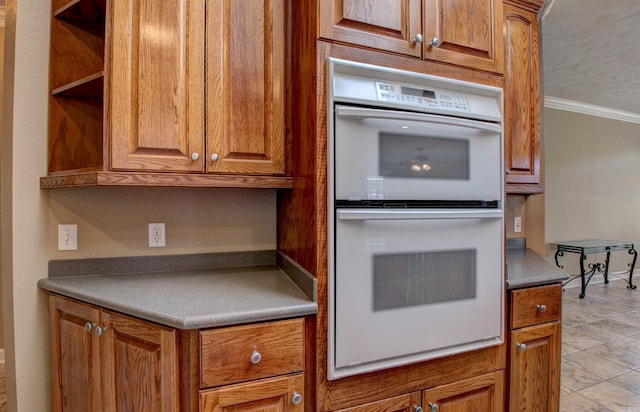 kitchen featuring ornamental molding, open shelves, double oven, and brown cabinetry