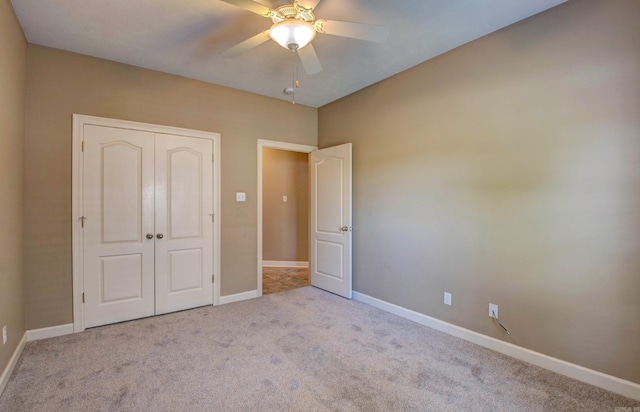 unfurnished bedroom featuring a ceiling fan, baseboards, carpet, and a closet