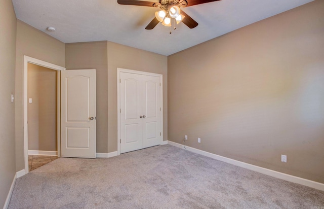 unfurnished bedroom featuring baseboards, ceiling fan, and carpet flooring