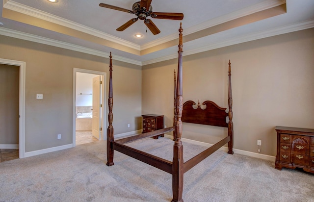 carpeted bedroom with baseboards, ornamental molding, and a tray ceiling