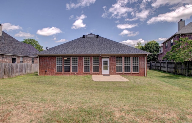 rear view of house featuring a fenced backyard, a yard, a patio area, and brick siding