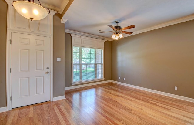 entrance foyer with baseboards, ornamental molding, and ceiling fan