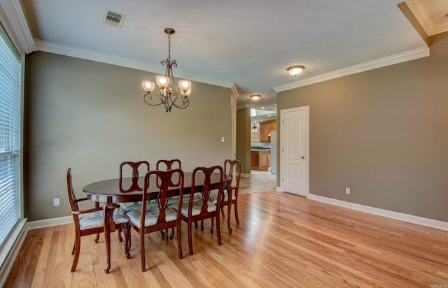 dining room featuring visible vents, crown molding, and a healthy amount of sunlight