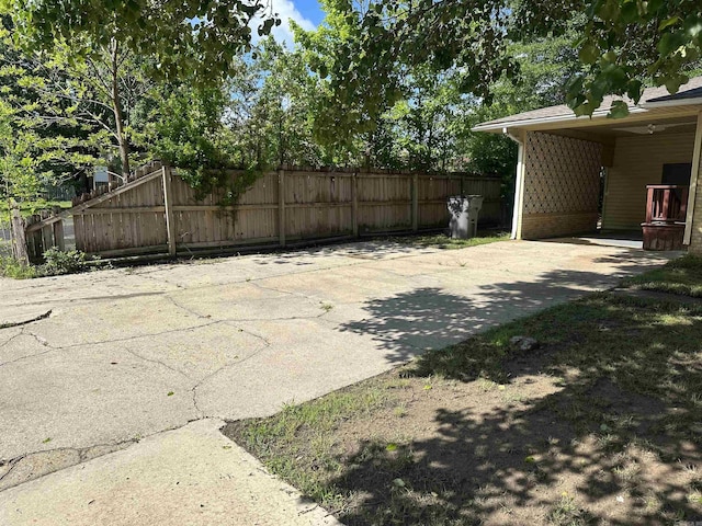 exterior space with fence and concrete driveway