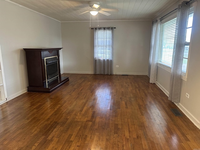 unfurnished living room featuring ornamental molding, dark wood-type flooring, ceiling fan, and visible vents
