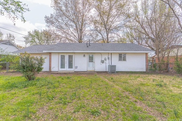 3210 Kingsbury St, Jonesboro, AR 72401 - back of house featuring a lawn, french doors, central AC unit, and a fenced backyard