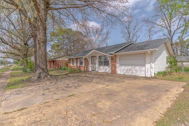 3210 Kingsbury St, Jonesboro, AR 72401 - ranch-style house featuring a garage, a shingled roof, concrete driveway, and brick siding