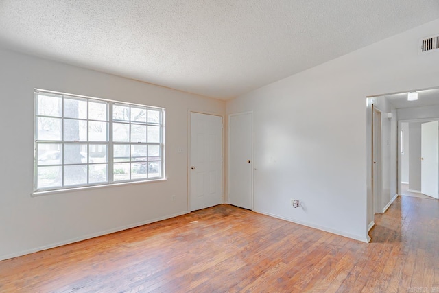 3210 Kingsbury St, Jonesboro, AR 72401 - spare room with a textured ceiling, baseboards, wood finished floors, and visible vents