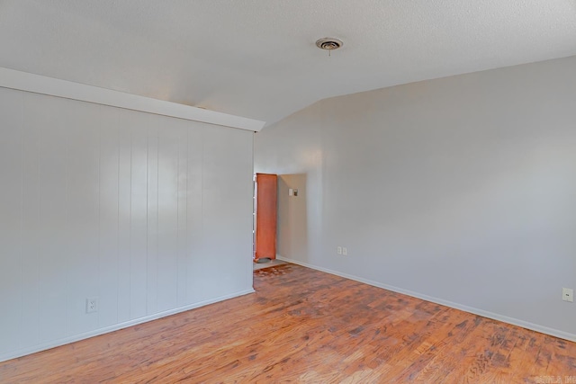 3210 Kingsbury St, Jonesboro, AR 72401 - unfurnished room featuring baseboards, wood finished floors, and lofted ceiling