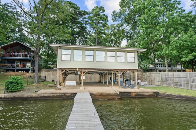 exterior space with a fenced backyard, a patio, and a water view
