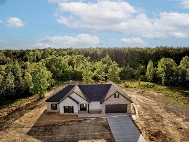 birds eye view of property featuring a view of trees