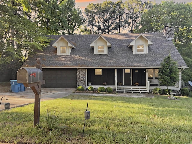 view of front of property featuring concrete driveway, a chimney, a front yard, and a garage