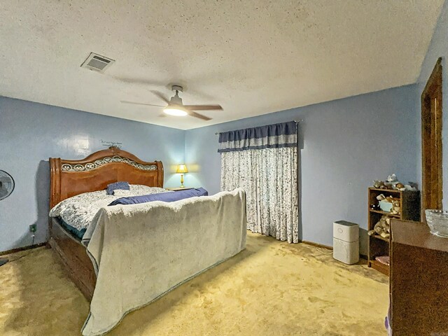 bedroom with carpet floors, a textured ceiling, visible vents, and ceiling fan