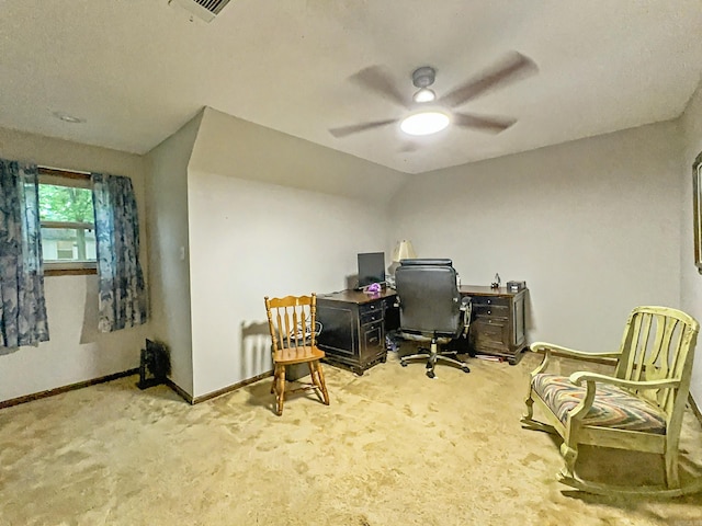 carpeted office space with baseboards and ceiling fan