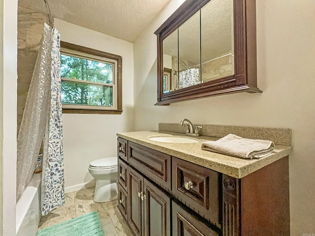 full bathroom with toilet, a textured ceiling, baseboards, and vanity