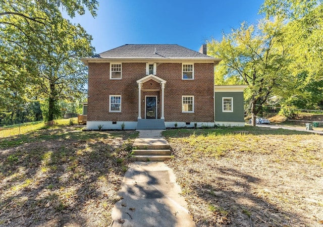 colonial-style house with crawl space, brick siding, fence, and a chimney