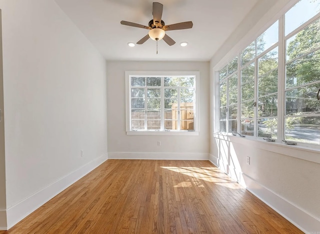 spare room featuring a ceiling fan, baseboards, recessed lighting, and wood finished floors