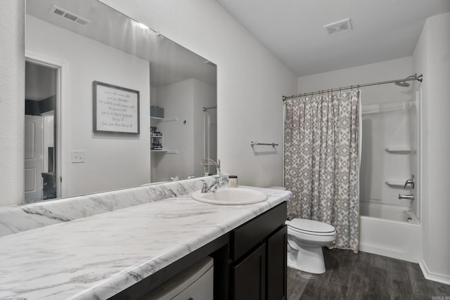 bathroom featuring vanity, toilet, wood finished floors, and visible vents